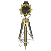 An adjustable tripod spotlight  with a gold-colored aluminum body and a wooden tripod stand, featuring a spotlight lens at the top.